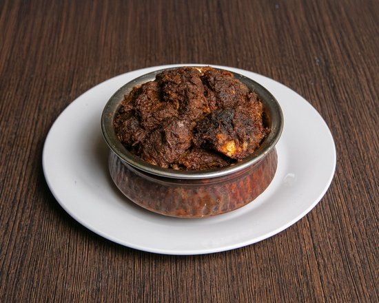 Signature traditional Bengali Beef Kala Bhuna cooked in copper handi