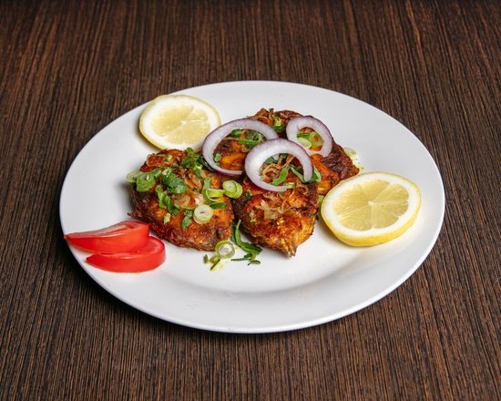 Crispy Bengali style Fish Fry served with lemon and sliced onions